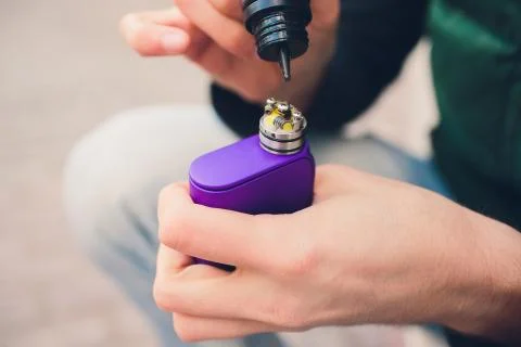 Maintenance of electronic mech mod vaping device.Modern vaporizer e-cig gadget Stock Photos