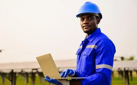 Maintenance engineer checking and installing solar panels on solar cell farm Stock Photos