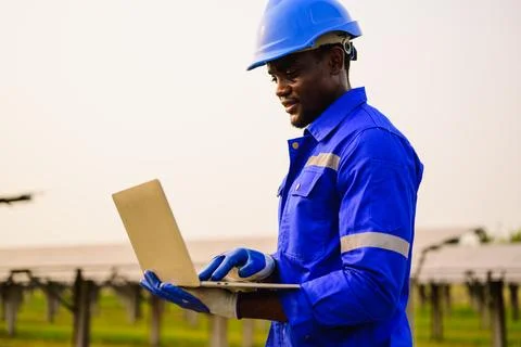 Maintenance engineer checking and installing solar panels on solar cell farm Stock Photos