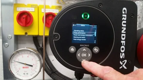 Maintenance engineer checking parameters on a pump set Stock Footage 96463735