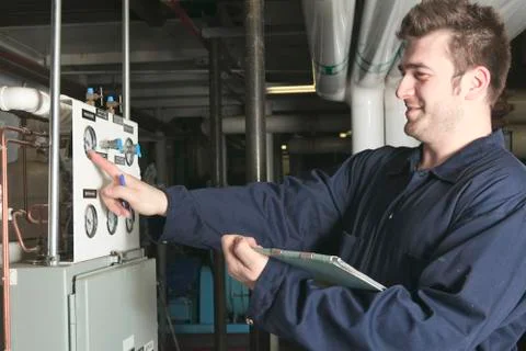 Maintenance engineer checking technical data of heating system e Stock-Fotos