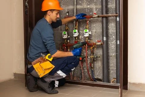 Maintenance engineer checking technical data of heating system equipment in a Stock Photos