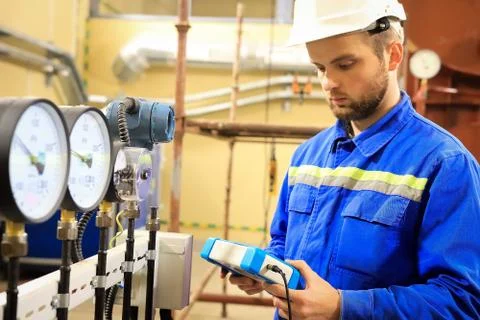 Maintenance engineer  controls a work  technological process and tests a work Stock Photos