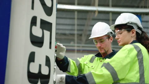 Maintenance engineer inspects machinery in a cardboard parts factory. Stock Footage 252090980