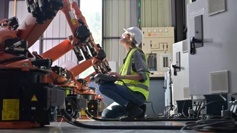 Maintenance engineer worker working with robotic machine at factory Stock Footage 241525574