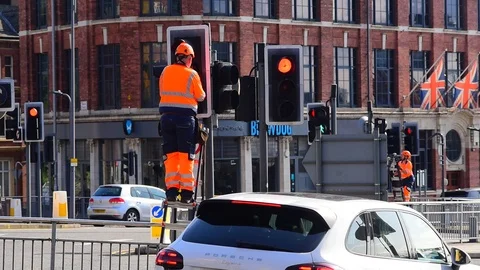 Maintenance engineer working on traffic light in the city of leeds uk Stock Footage 114121051