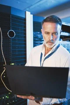 Maintenance, laptop or man in server room with check, network or system analysis Stock Photos