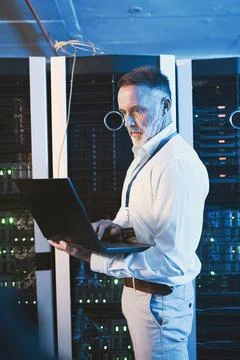 Maintenance, laptop or technician in server room with review, network or system Stock Photos
