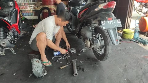 Maintenance motorcycle in workshop Stock Footage 249288130