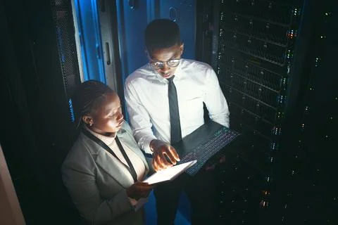 Maintenance, review or team in server room with tech, network or system Stock Photos