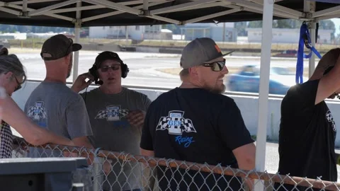 Maintenance support crew watching car racing. Stock-Footage 157805254