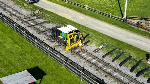 Maintenance Work Being Done on Railway Tracks in a Rural Setting During Day.. Stock Photos