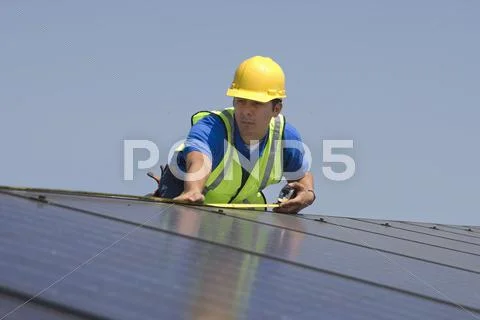 Maintenance Worker Measuring Solar Panels Stock Photos