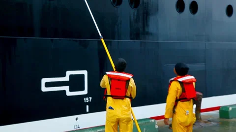 Maintenance worker reparing and painting the exterior of the cruise ship Stock Footage 29823948