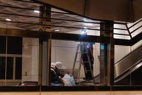 Maintenance Workers Repairing Ceiling Inside Closed Taipei Metro Station. 写真素材