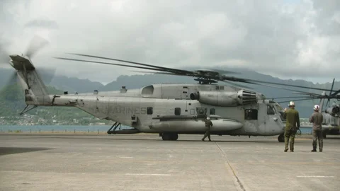 Maintenance workers watch preparation of helicopter Stock Footage 117729912