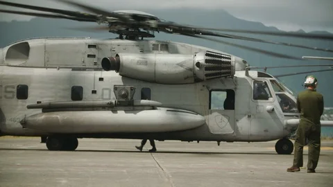 Maintenance workers watch preparation of helicopter Stock Footage 117730169