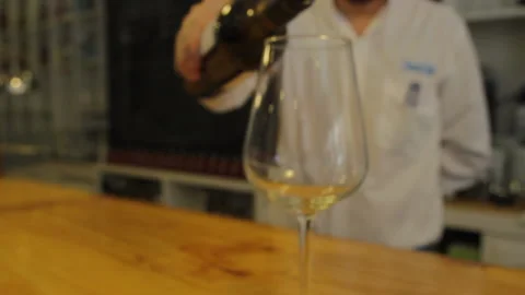 The maitre d 'of a restaurant serving a glass of red wine, Stock-Footage 137355029
