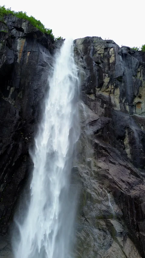 Majestic 4k Waterfall Cascading Down Rocky Cliffs in a Natural Setting, Norway Stock Footage 296013033