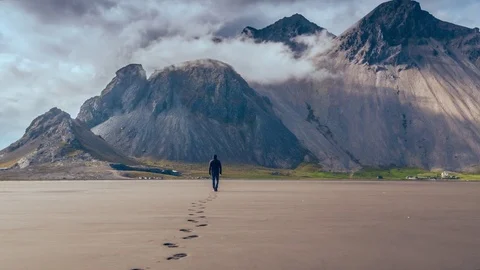 Majestic Aerial Flight Brave Young Man Walking to Beautiful Iceland Mountian Stock Footage