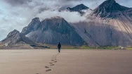 Majestic Aerial Flight Brave Young Man Walking To Beautiful Iceland Mountian Stock Footage