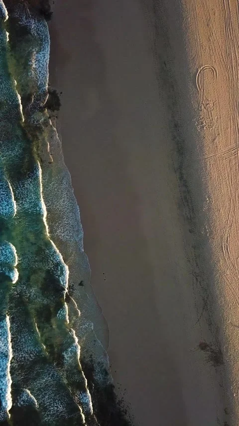 Majestic aerial top-down perspective capturing ocean waves with white foam Stock Footage 344815835