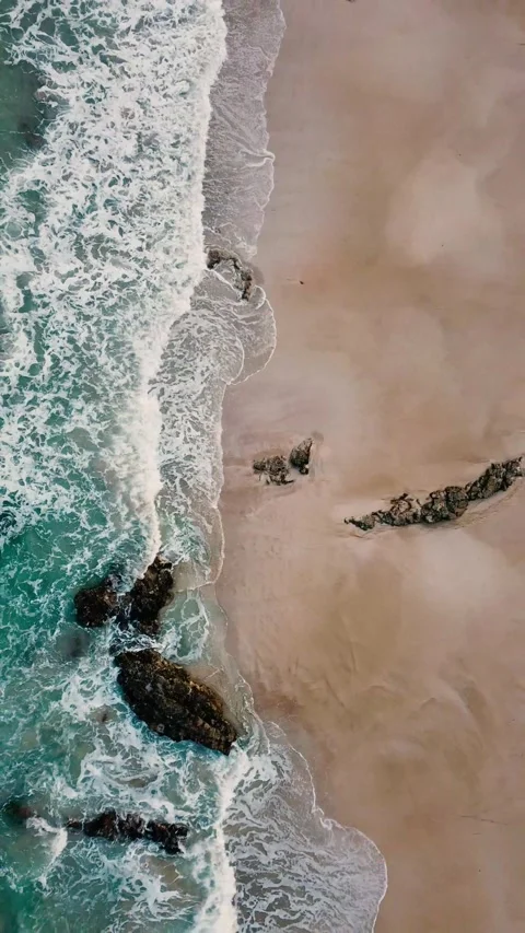 Majestic aerial top-down perspective of turquoise ocean waves gently crashing Stock Footage 344838652