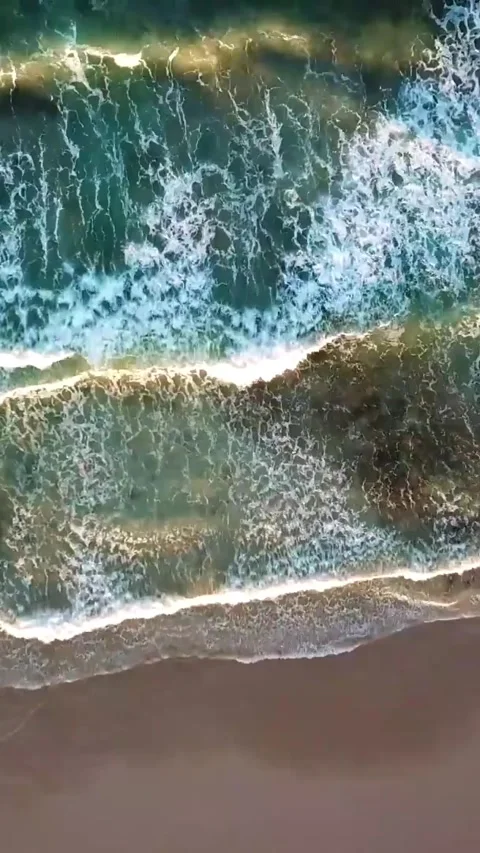 Majestic aerial top-down view of turquoise ocean waves gently rolling and Stock Footage 344815833