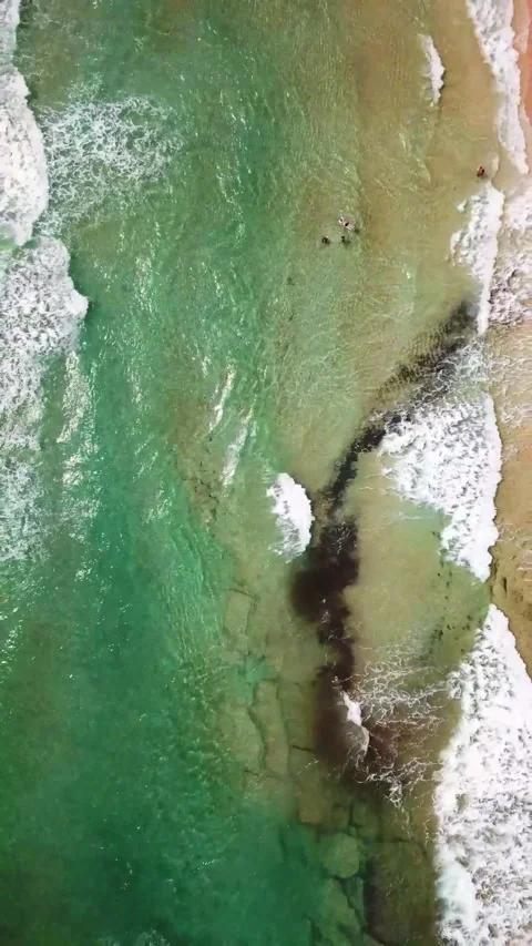 Majestic aerial top-down view of beautiful turquoise ocean waves breaking on a Stock Footage 344840975