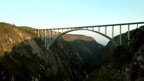 Majestic arch bridge spans a large valley Stock Footage 141372653