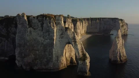 Majestic Cliffs of Etretat at Sunset Capturing Nature's Radiance Stock Footage 280305701