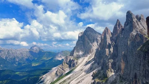 Majestic clouds drifting gracefully over the stunning tre cime di lavaredo in Stock Footage 283297110