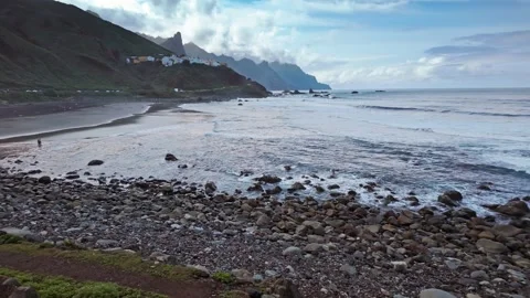 Majestic clouds drifting over a rugged rocky coastline Stock Footage 294685013