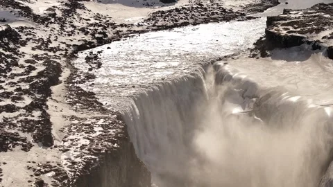 Majestic Dettifoss waterfall thunders over a snowy basalt canyon in North Stock Footage 310291783