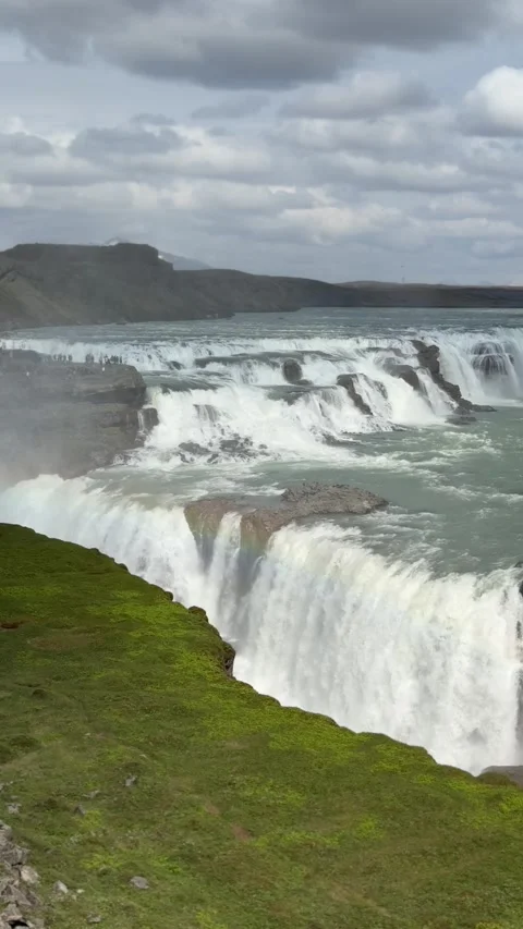 Majestic Gullfoss waterfall thunders down Iceland’s rugged canyon, surrounded  Stock Footage 312232905