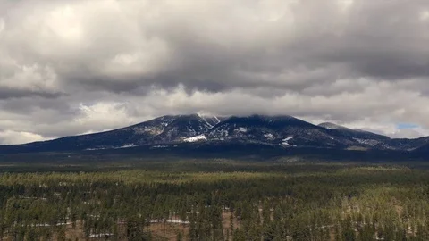Majestic hyperlapse of thick clouds building up over mountain range and forest Stock Footage 124805421