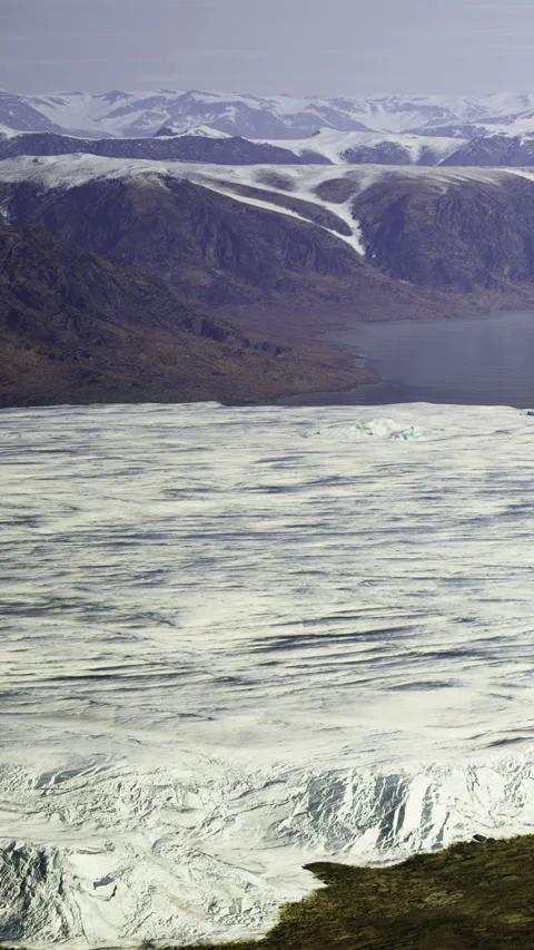 Majestic ice fields stretch across tranquil waters in a remote landscape Stock Footage 334246070