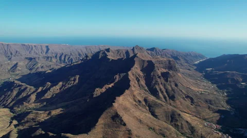 Majestic Mogan mountains casting long shadows over Gran Canaria Stock Footage 313626934