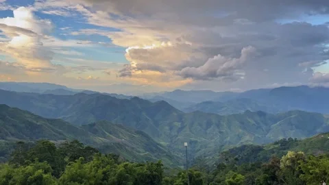 Majestic Mountain Landscape with Dramatic Clouds and Rolling Hills Stock Footage 318437589