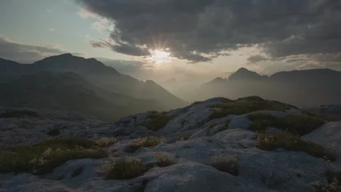 Majestic Mountain Landscape with Dramatic Sky and Sunlight Stock Footage 323301488