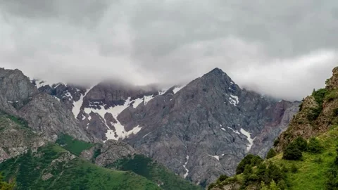 Majestic Mountain Range Enveloped in Clouds and Mist Stock Footage 308281428