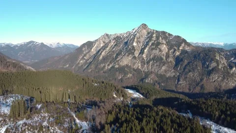 A majestic mountain range with snow-capped peaks and green spruce forests. Stock Footage 303636428