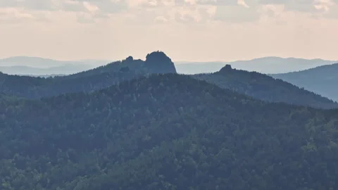 A Majestic Mountain Range With Towering Trees in the Foreground Stock Footage 257122341