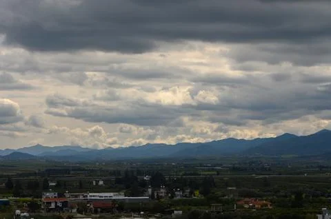 Majestic mountain range under a brooding sky at twilight's embrace in a tra.. Stock Photos