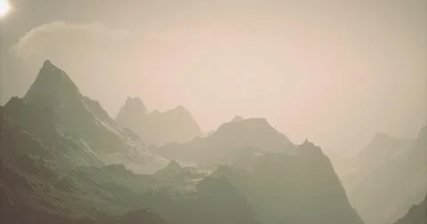 Majestic mountain range under a soft hazy sky during sunrise Stock Illustration