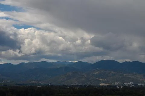 Majestic mountains under dramatic clouds create an enchanting landscape in .. Stock Photos