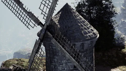 Majestic Old Windmill Stands Overlooking Lush Green Hills and Misty Valleys Stock Footage 344951264