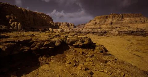 Majestic rock formations under dramatic sky at desert landscape location Illustrazione stock