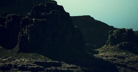 Majestic rocky formations under a dramatic sky at dusk Stock Illustration