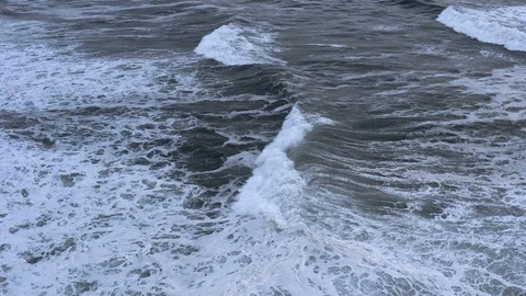 Majestic slow-motion wave rolls towards shore at dusk Stock Footage 112705257